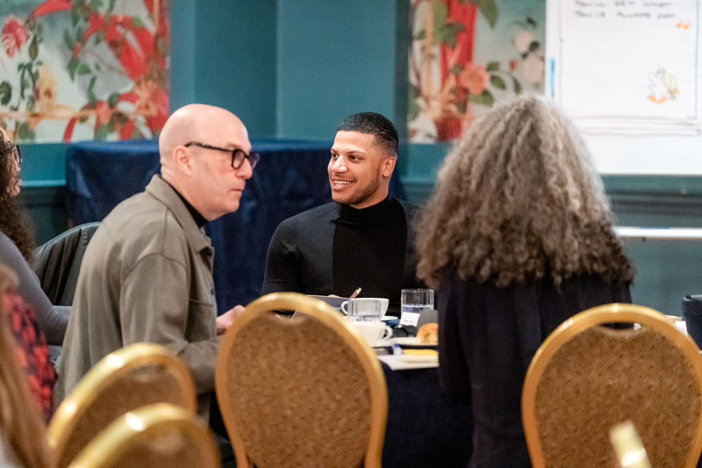 Three_Delegates_Talking_At_Table _In Training Session