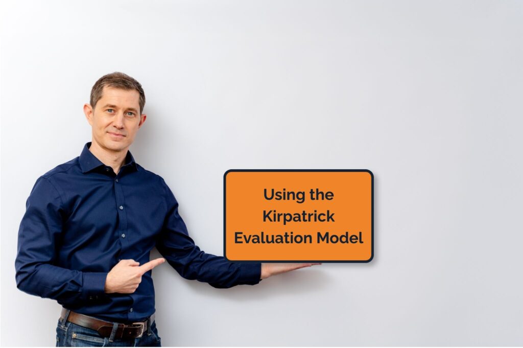 Photo of Ben Morton holding a Kirkpatrick Evaluation Model sign.